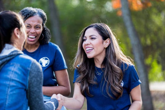 A woman shakes another woman's hand