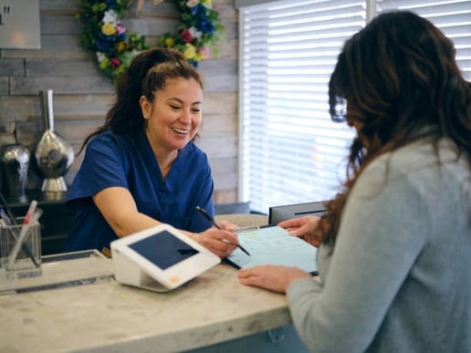 A receptionist helps a customer 