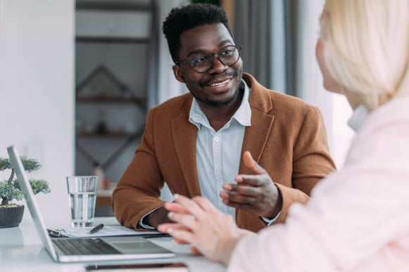 A man talks to a woman at work